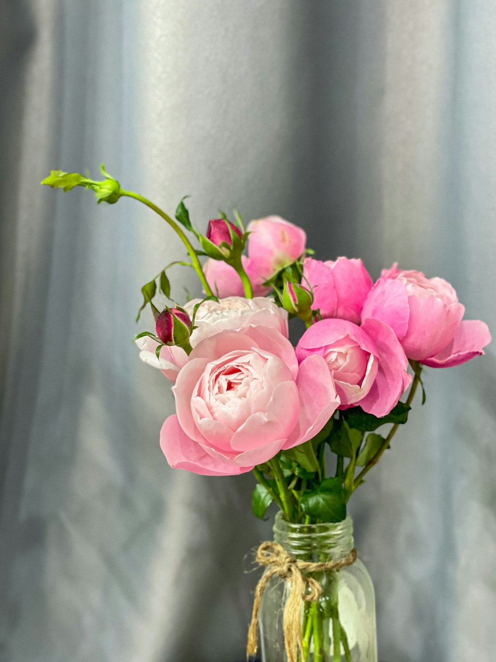 a vase filled with pink flowers on top of a table