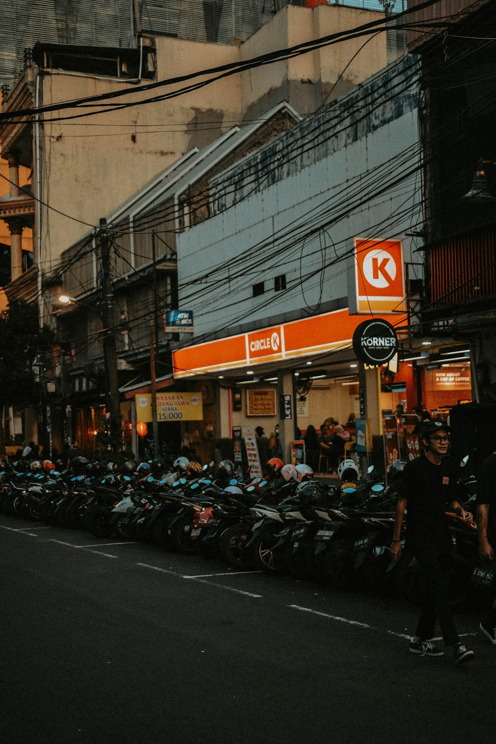 a row of motorcycles parked on the side of a street