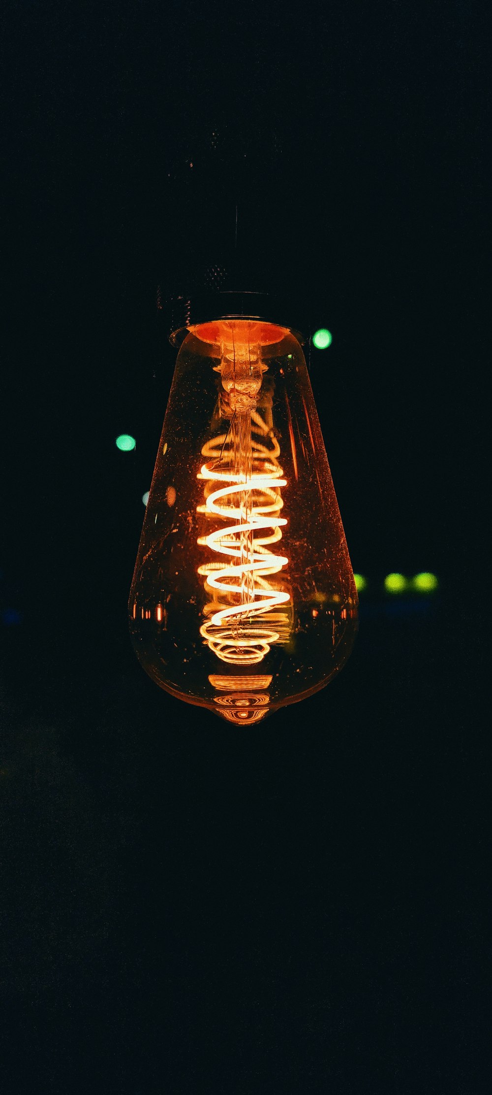 a light bulb hanging from the ceiling in the dark