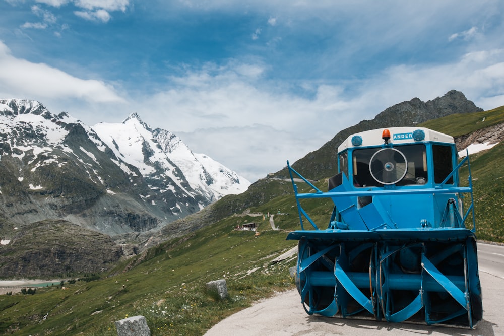 a blue and white truck parked on the side of a road