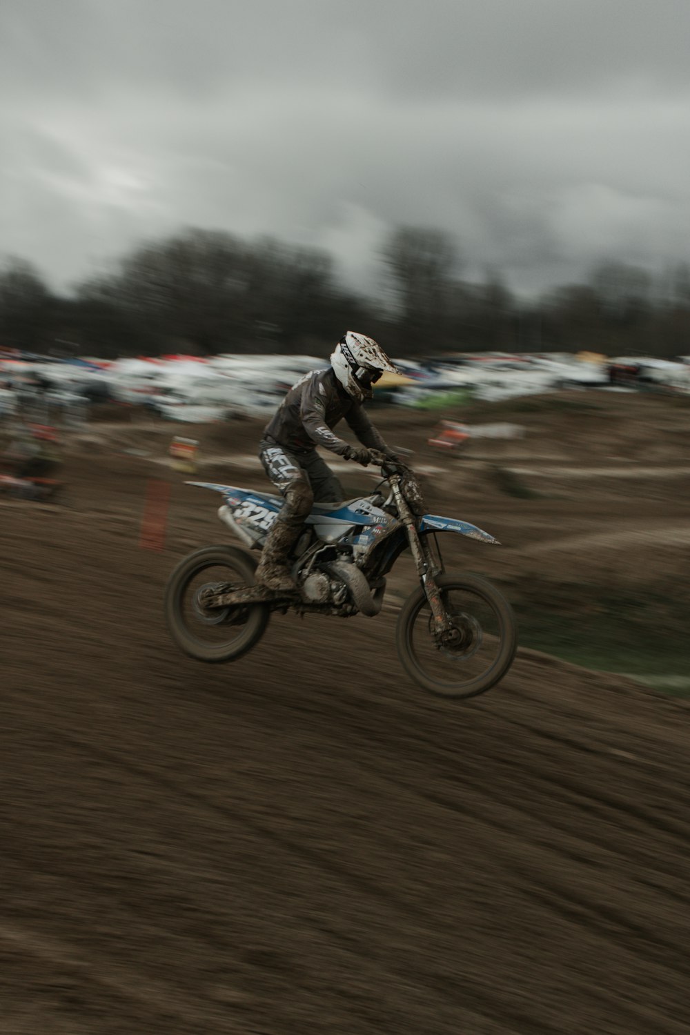 a man riding a dirt bike on top of a dirt field