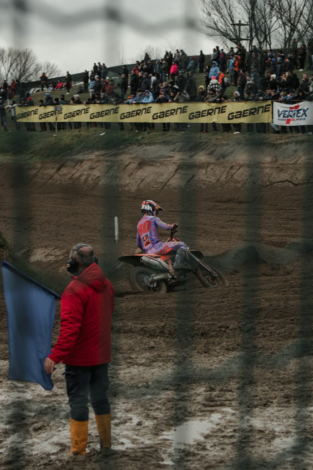 a man riding a dirt bike on top of a dirt field