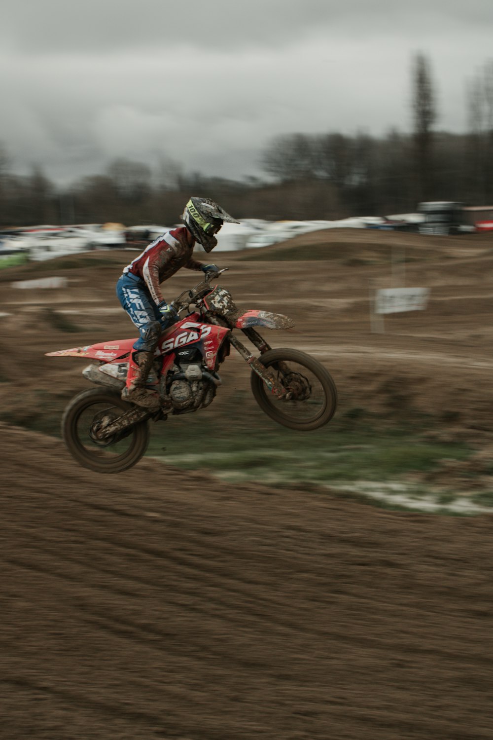 a man riding a dirt bike on top of a dirt field