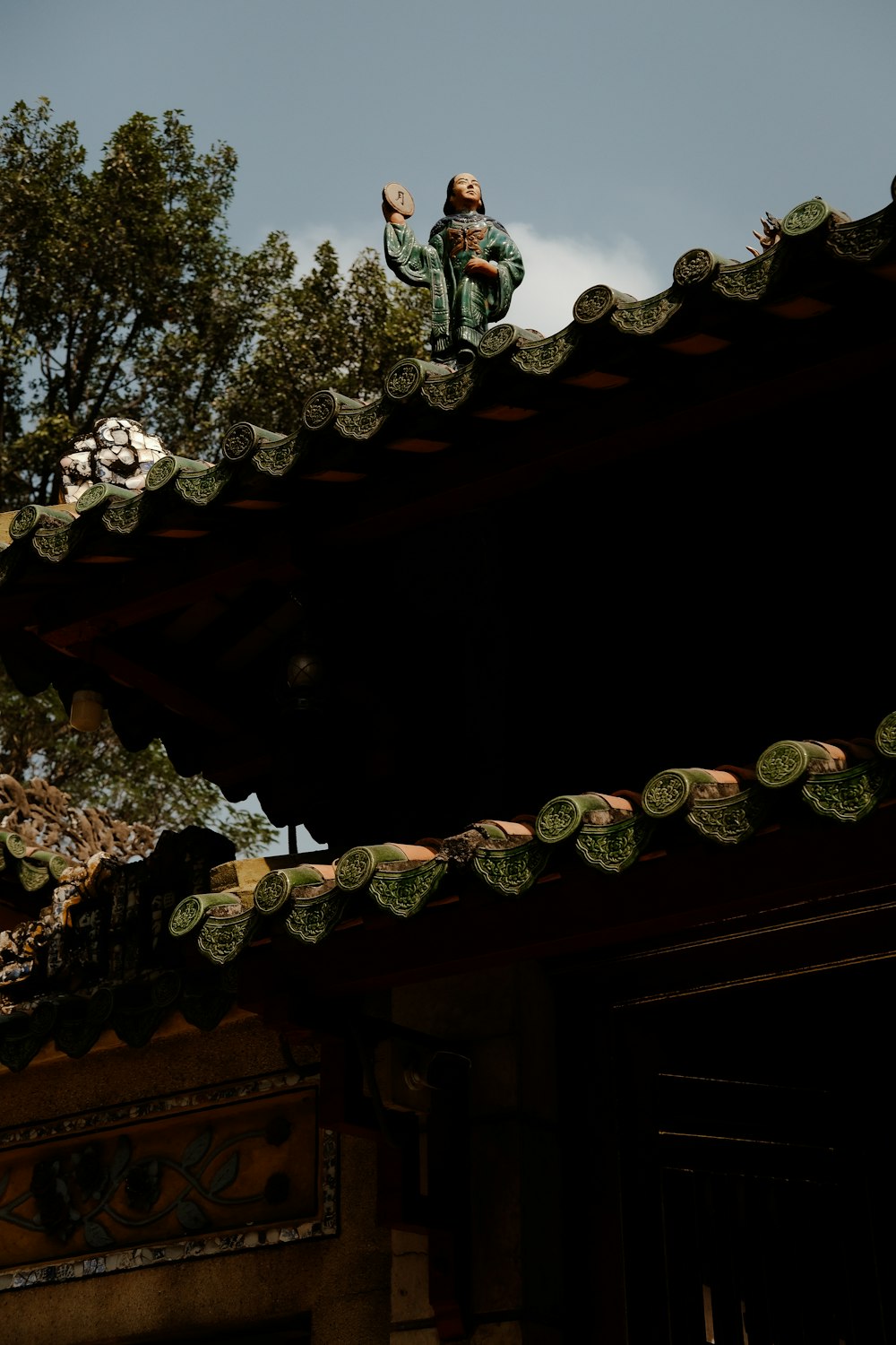 a man on top of a roof holding a frisbee