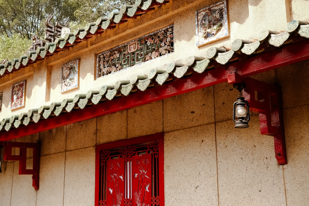 a building with a red door and a lantern