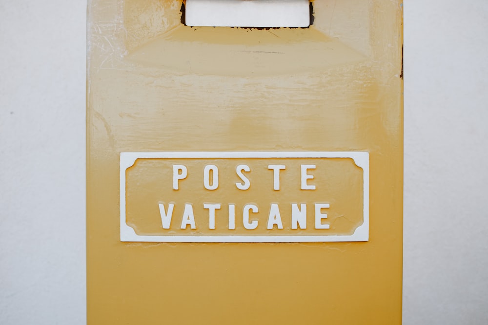 a yellow door with a white poste vaticane sign on it