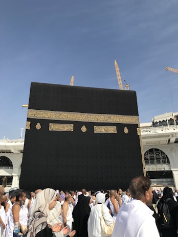 a group of people standing in front of a large building