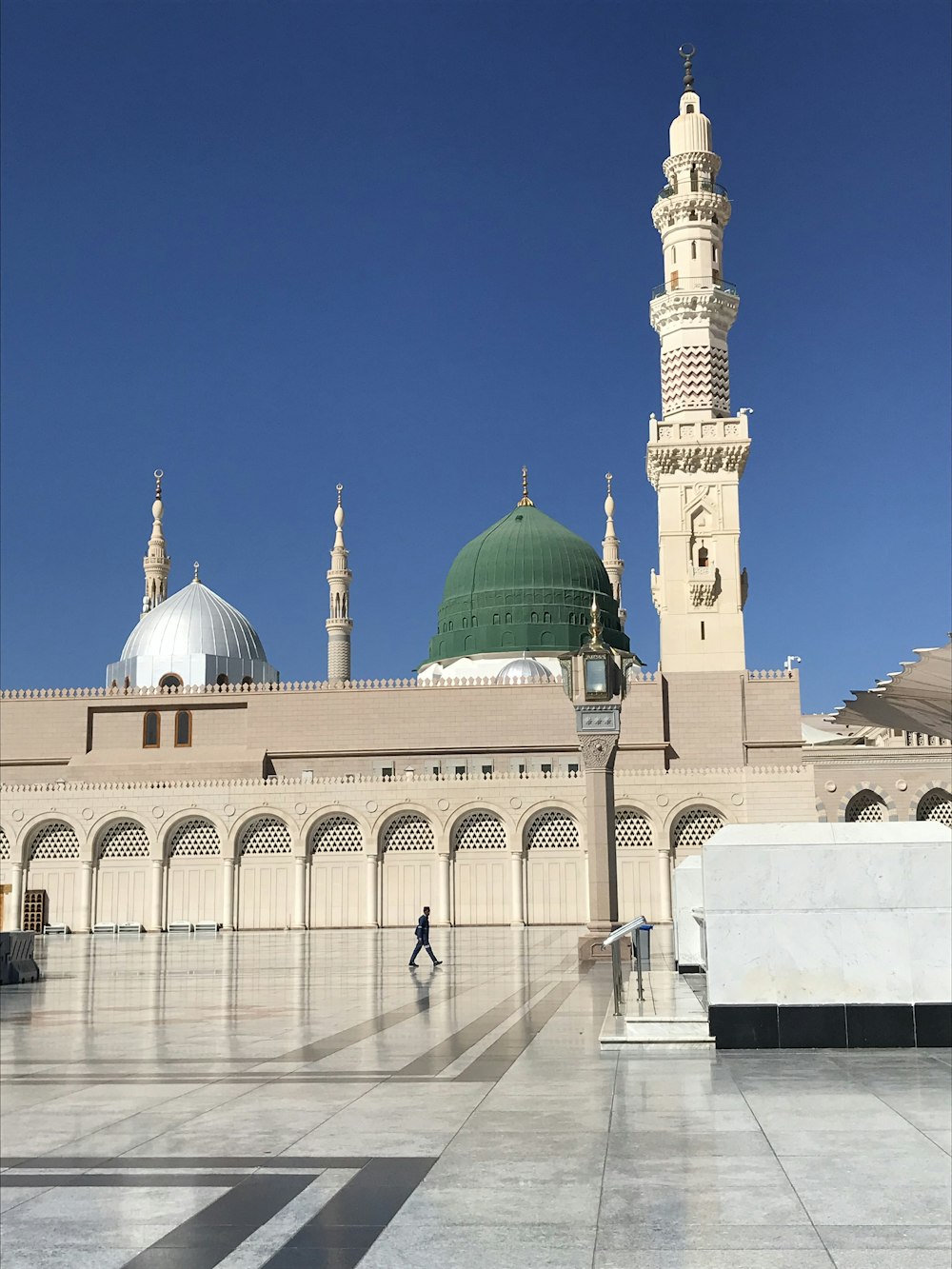 a large white building with a green dome