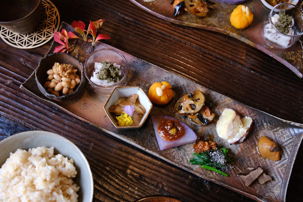 a wooden table topped with plates of food