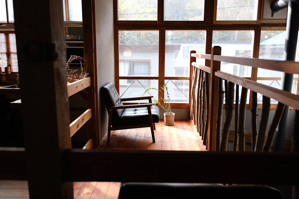 a chair sitting on top of a wooden floor next to a window