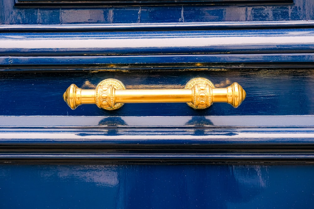 a close up of a blue door with a gold handle