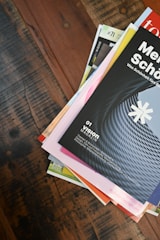 a stack of books sitting on top of a wooden table