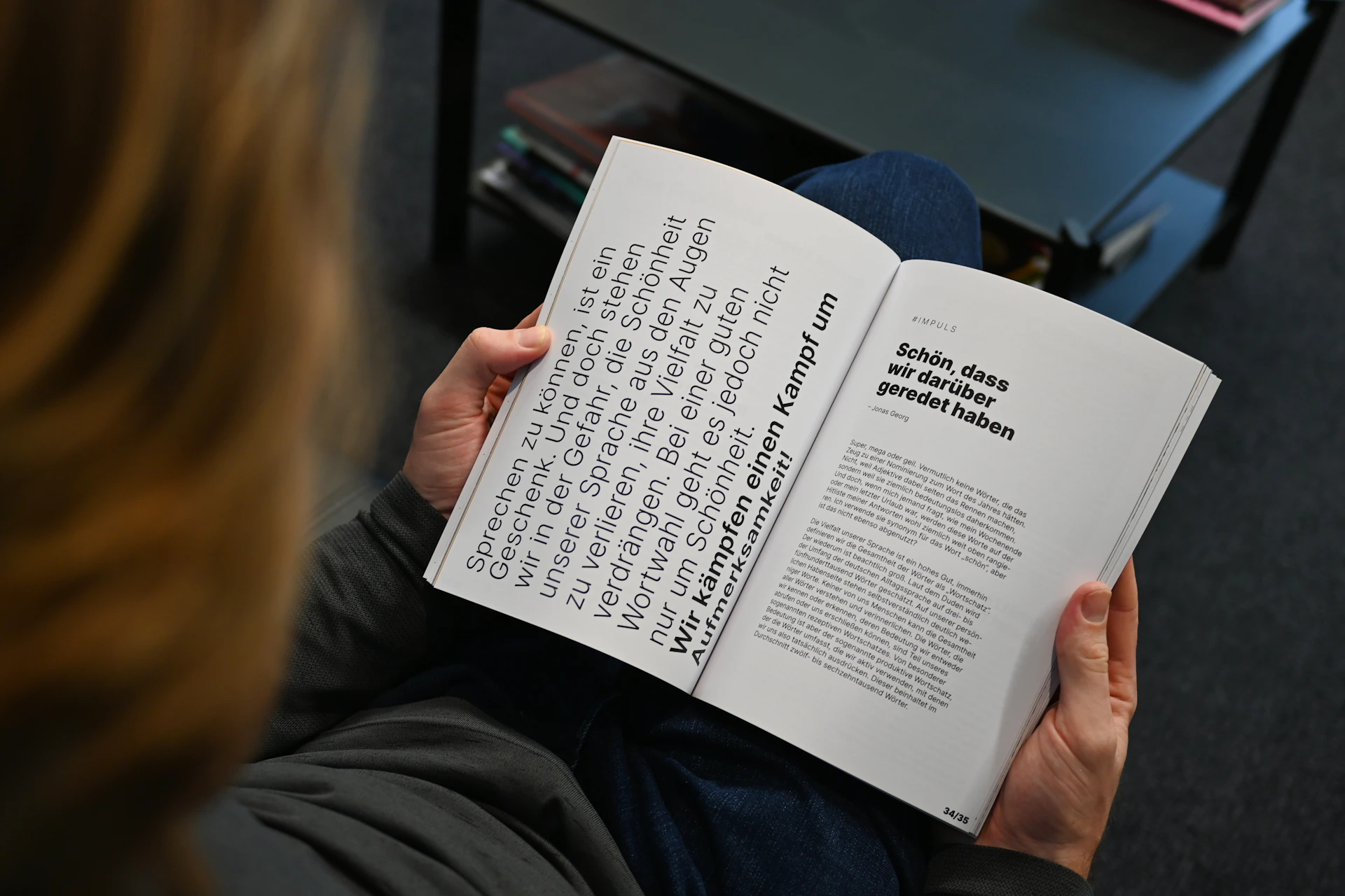 a person sitting down reading a book