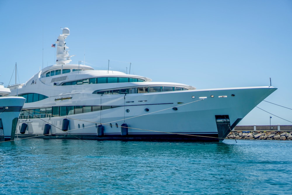 a large white boat docked at a dock