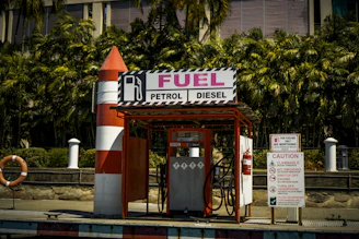 a gas station with a rocket on top of it