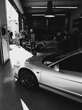 a black and white photo of a car in a garage