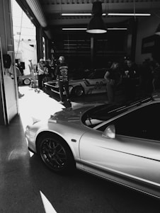 a black and white photo of a car in a garage