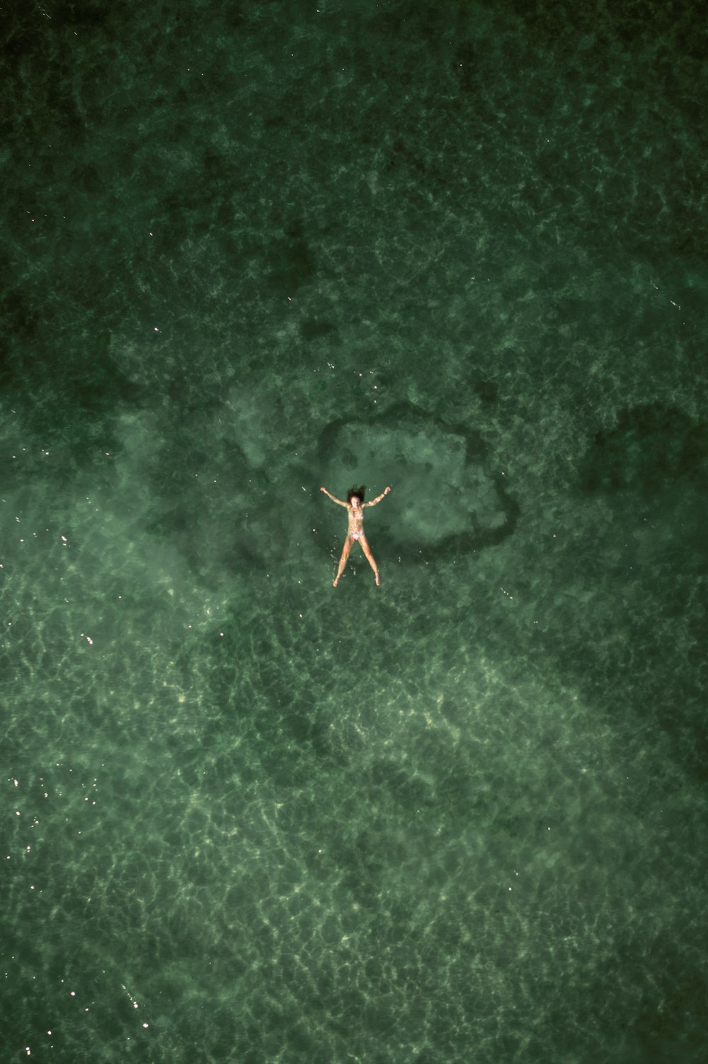 a person floating in a body of water