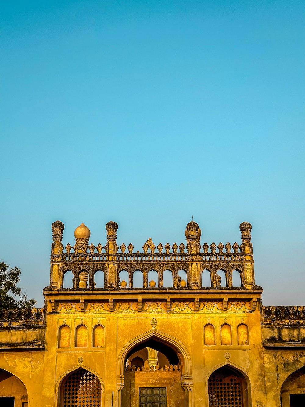 a yellow building with a clock tower in the background