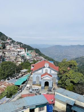 a view of a small town with mountains in the background