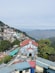 a view of a small town with mountains in the background