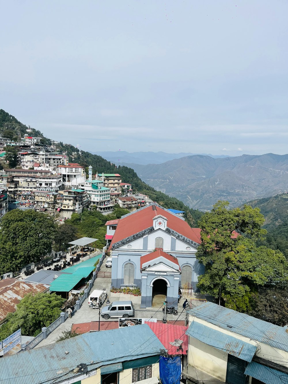 a view of a small town with mountains in the background