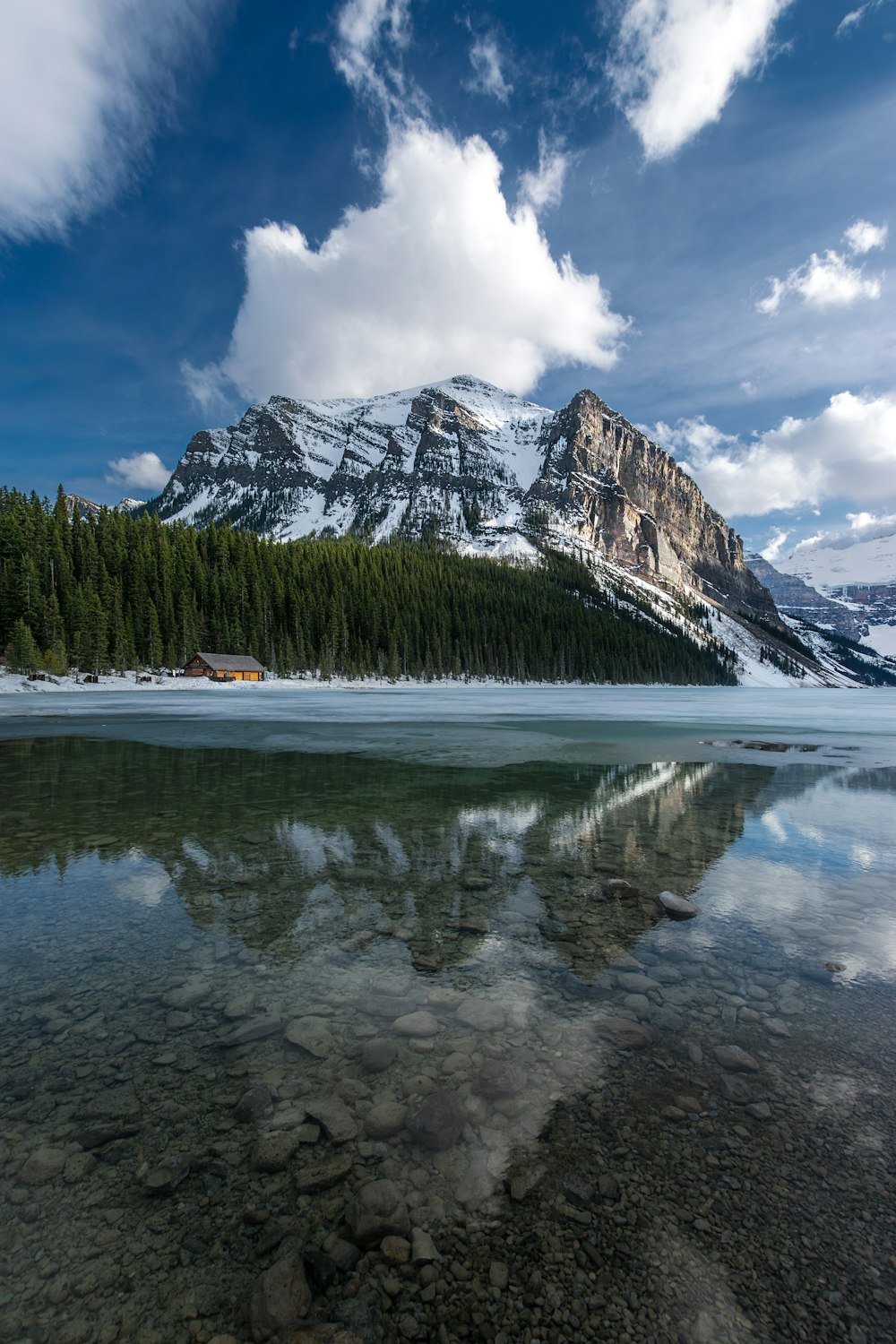 a mountain range with a lake in the foreground