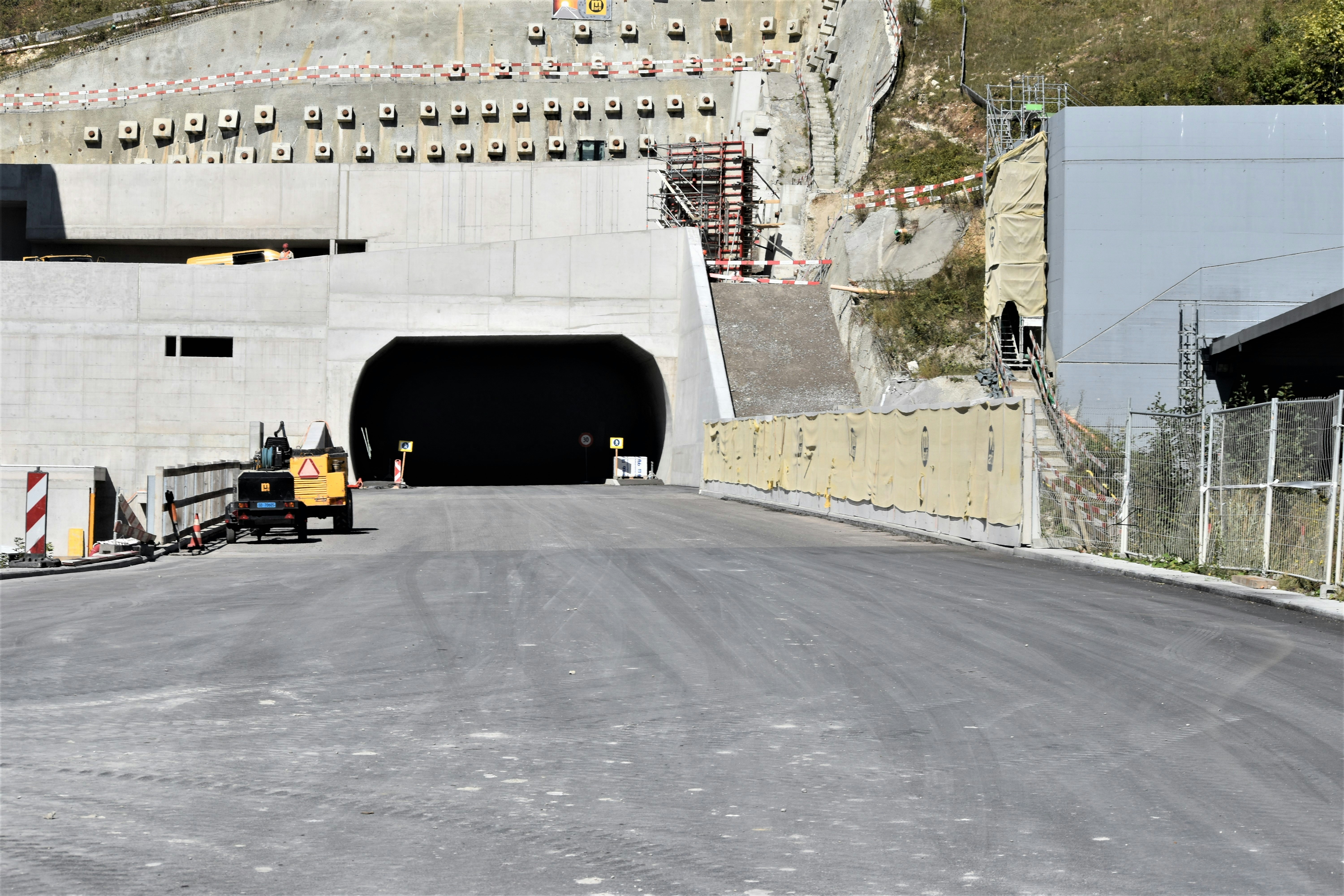 a construction area with a tunnel and construction equipment