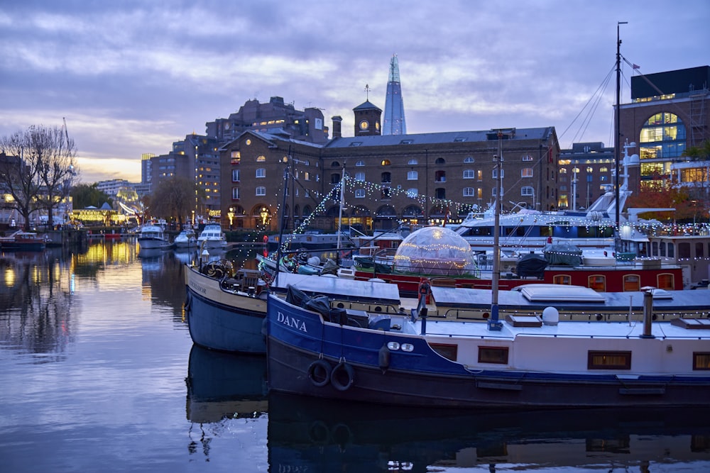 a harbor filled with lots of boats next to tall buildings