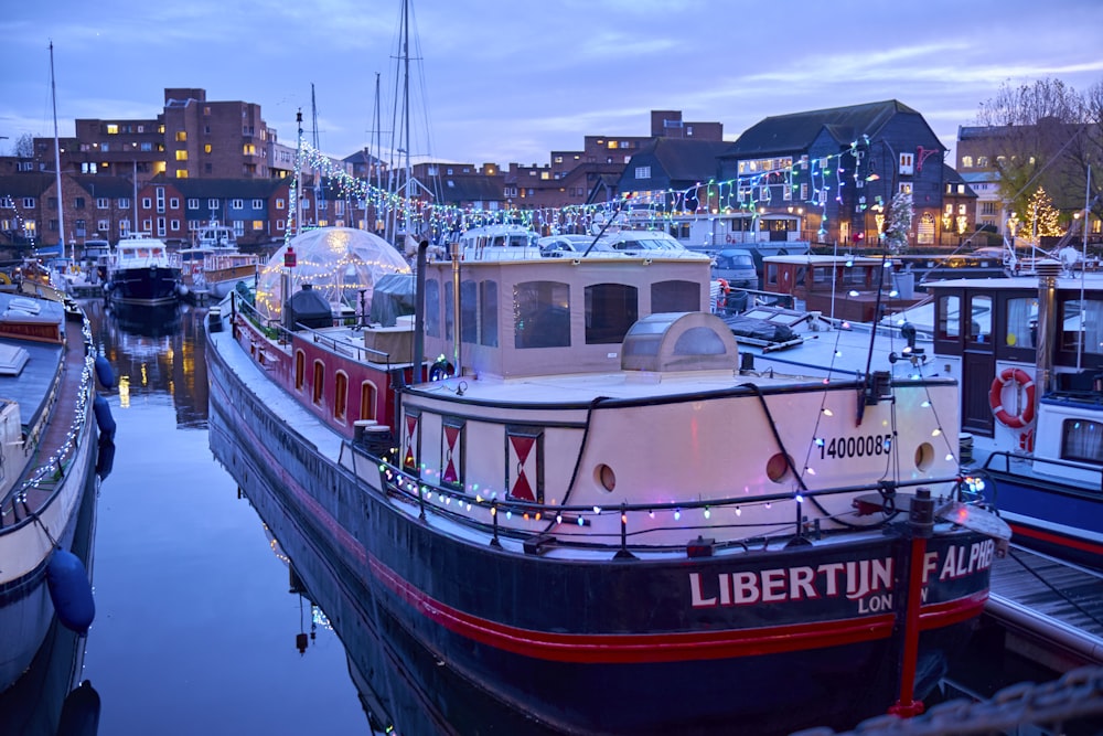 a harbor filled with lots of boats next to tall buildings