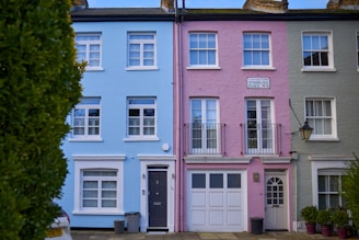 a row of multi - colored houses in a residential area