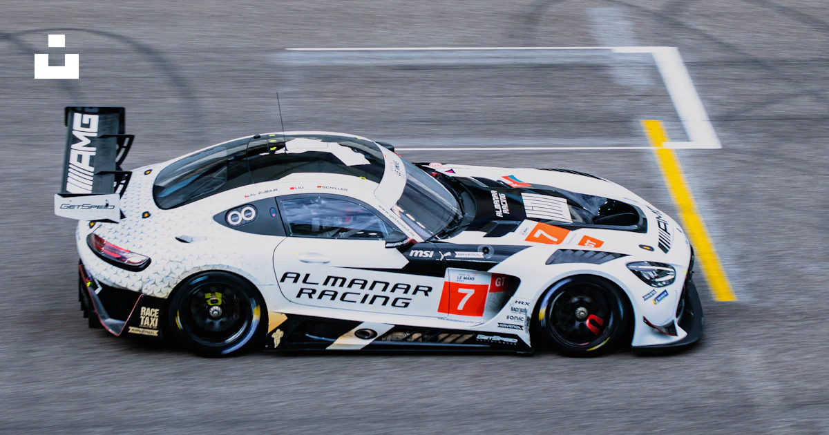 A white race car driving down a race track photo – Free Automobile ...