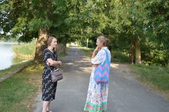 two women standing on a path talking to each other