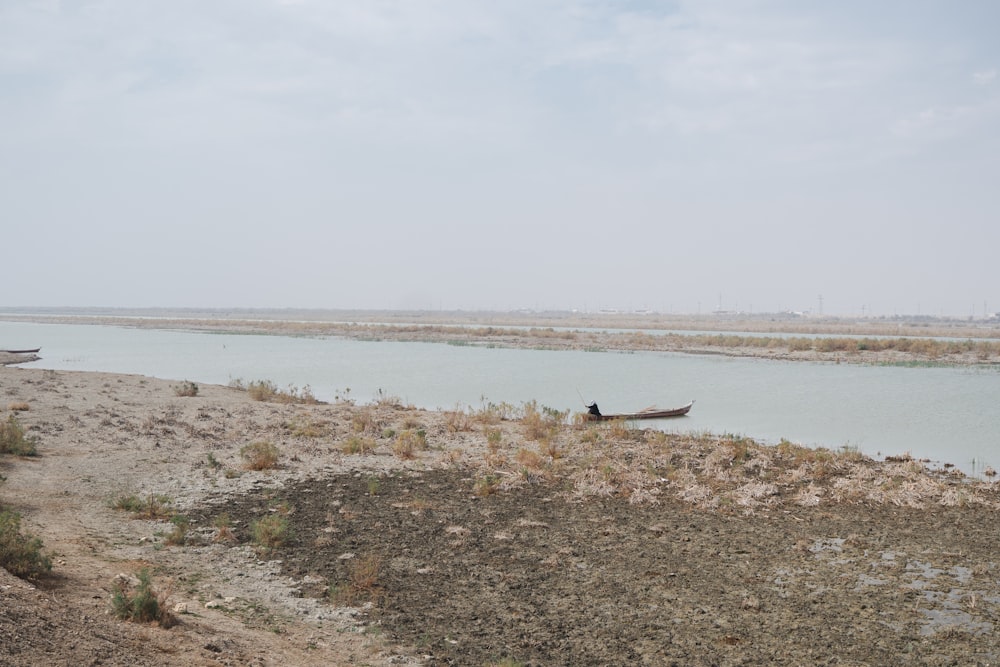 a small boat sitting on top of a river