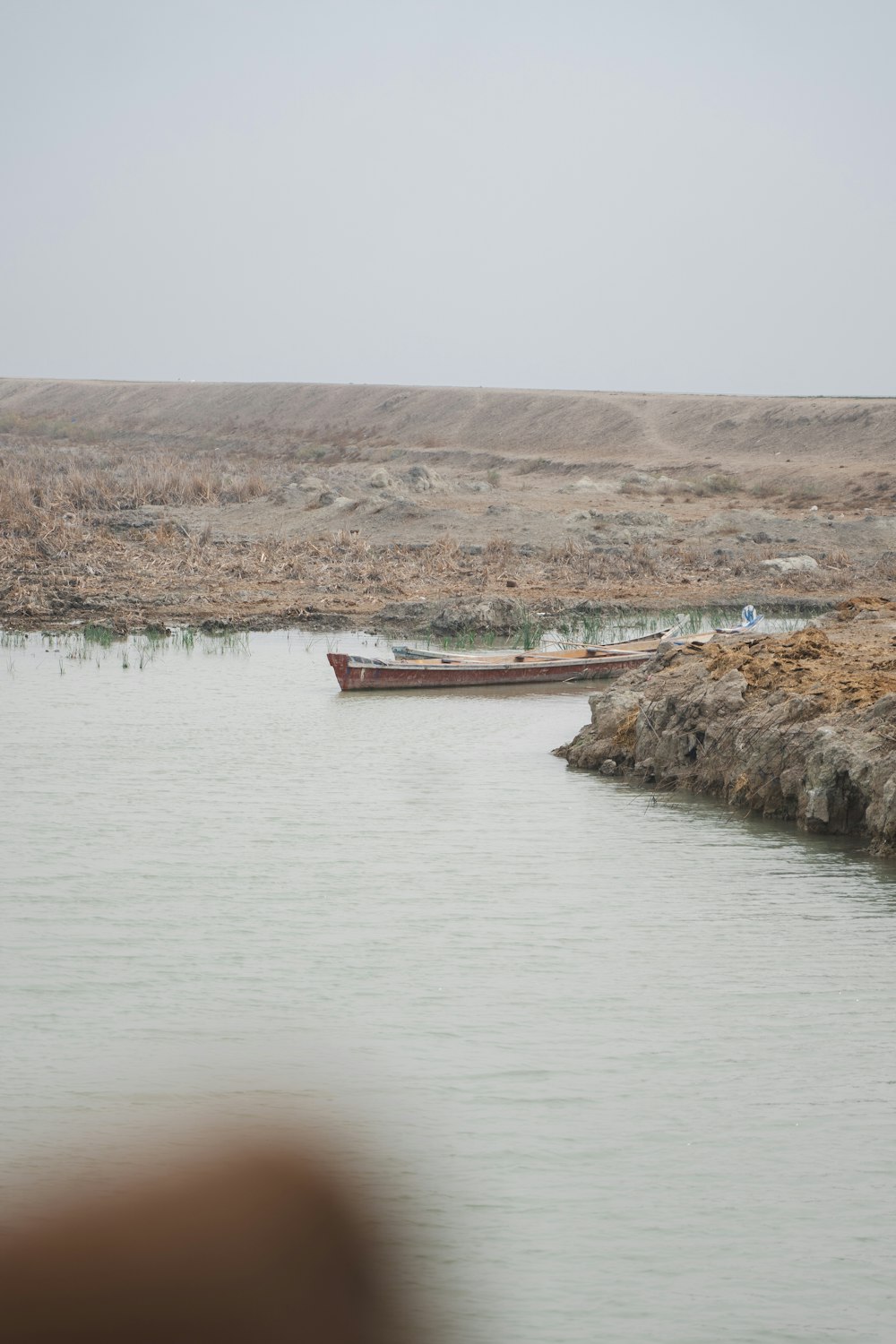 a couple of boats floating on top of a lake