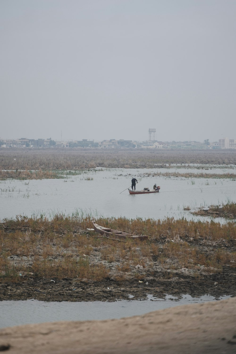 two people in a small boat on a body of water