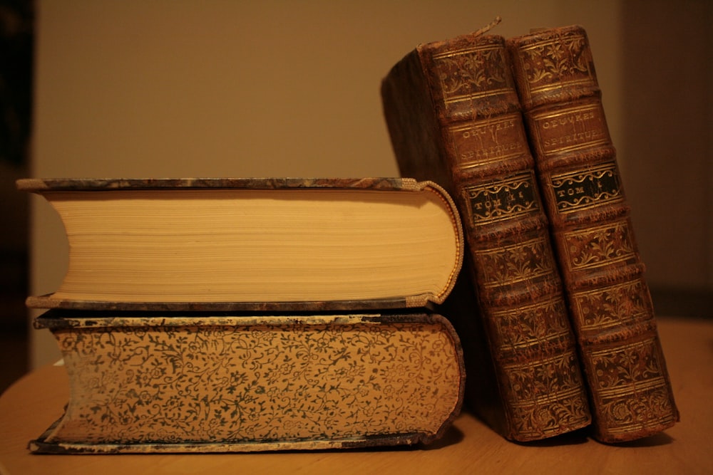 a couple of books sitting on top of a wooden table