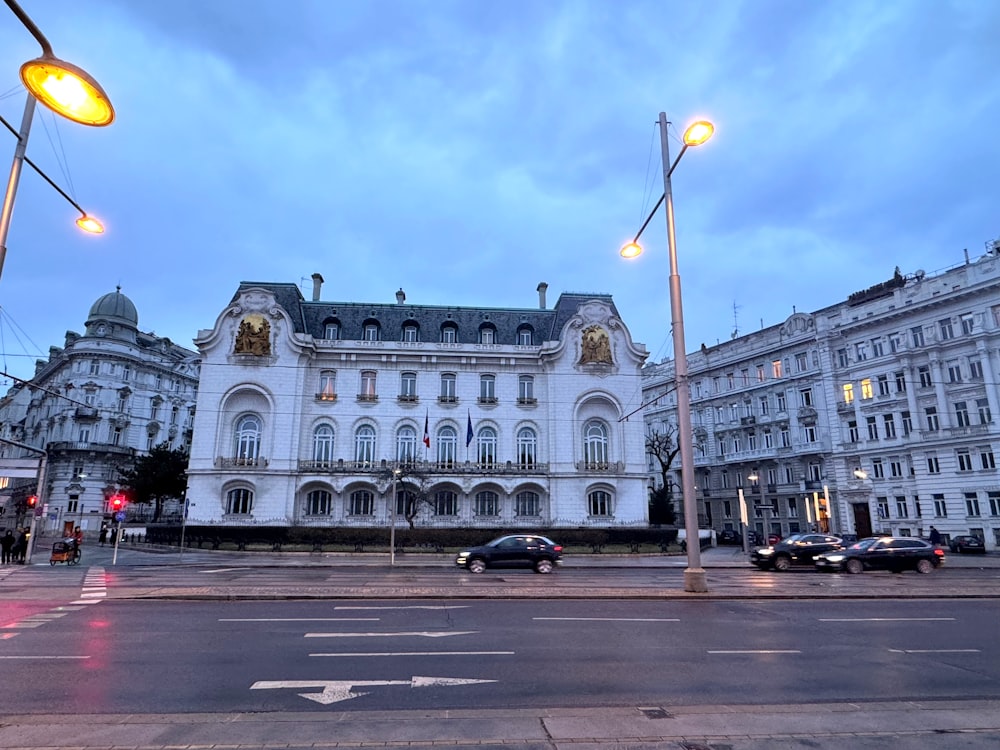 a large white building sitting on the side of a road