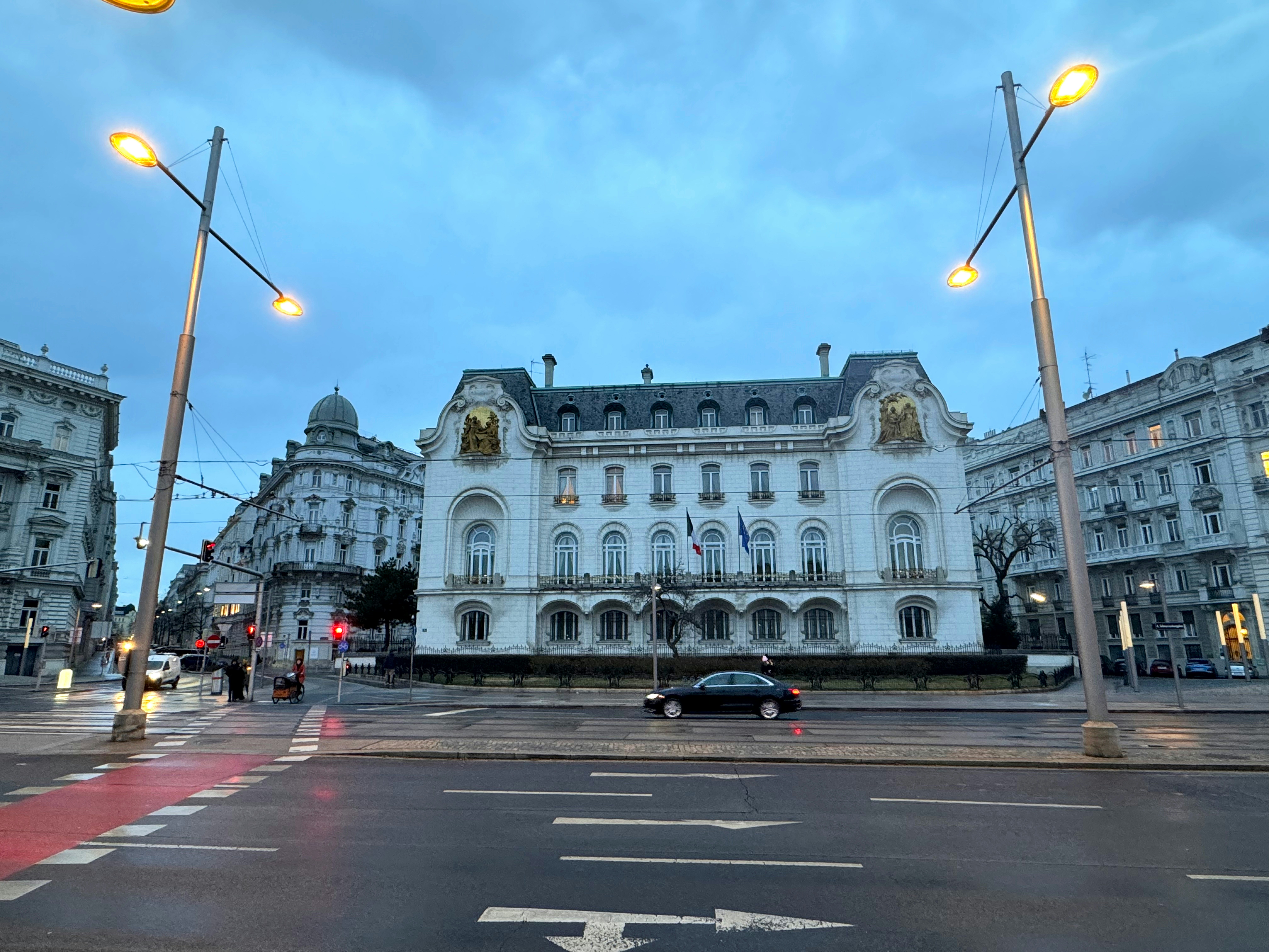 a large white building sitting on the side of a road