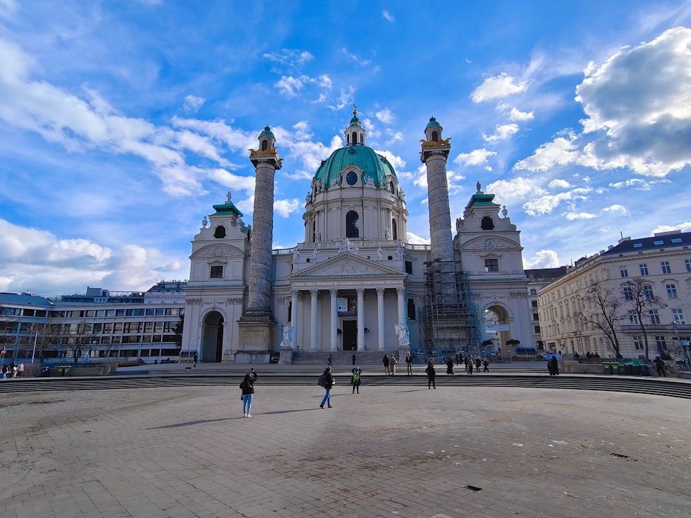 a large white building with a green dome