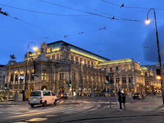 a city street with a large building in the background