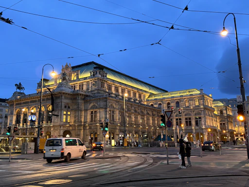 a city street with a large building in the background