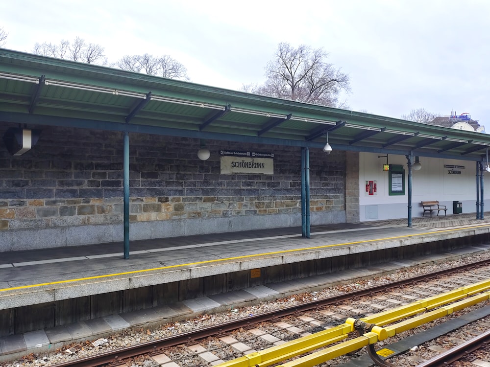 a train station with a train on the tracks