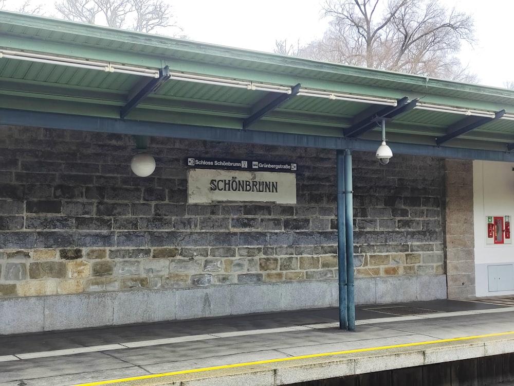 a train station with a sign on the side of it