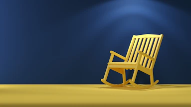 a wooden rocking chair sitting on top of a yellow floor