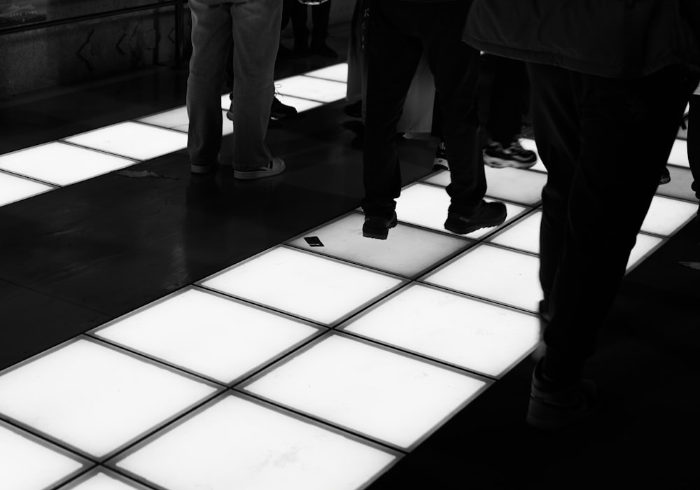 a group of people standing on a tiled floor