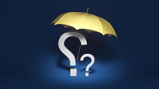 a yellow umbrella with a question mark underneath it