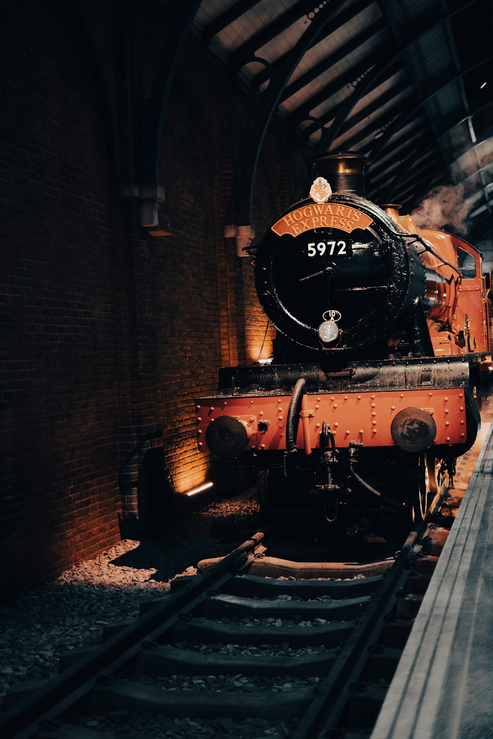 a train is sitting on the tracks in a train station