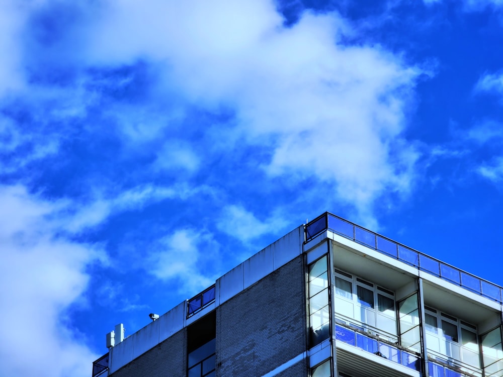 a tall building with balconies against a blue sky