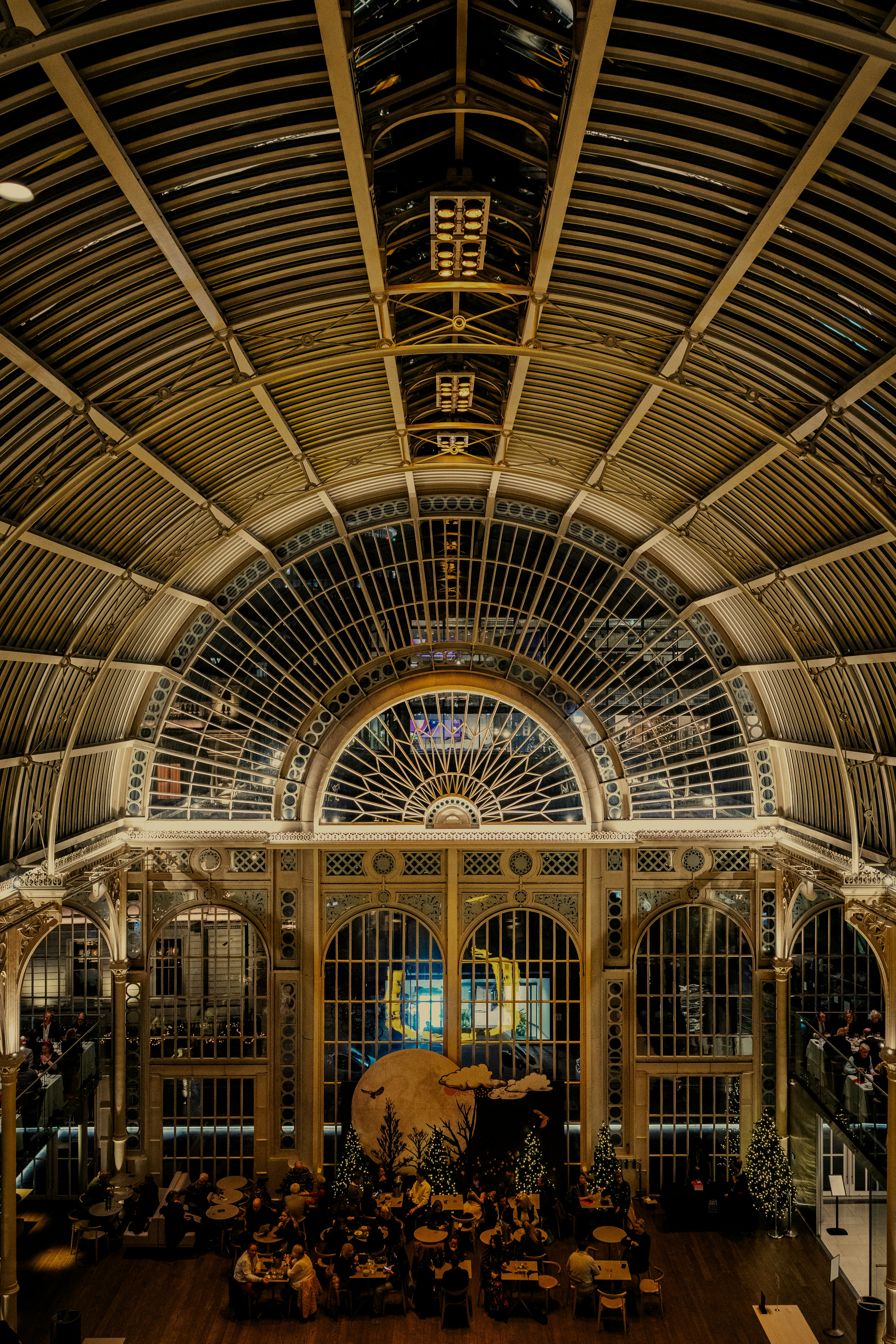 the inside of a train station with a clock on the ceiling